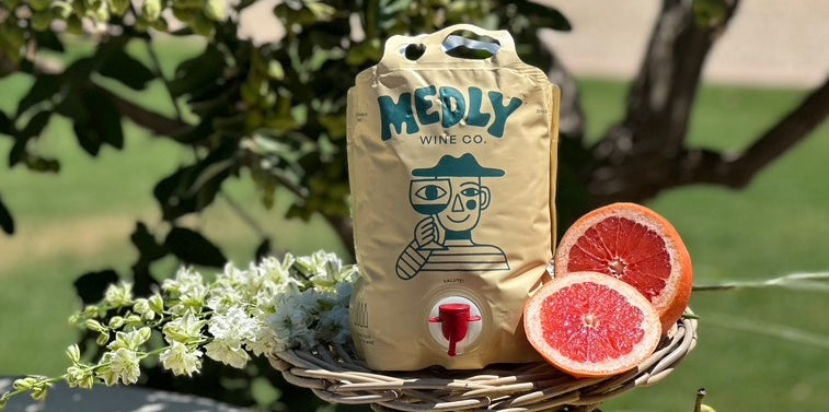  Medly Wine pouch in a sunny Mediterranean-style garden, featuring Gluten-Free, Organic, and Low-Sugar wine for easy sipping. 