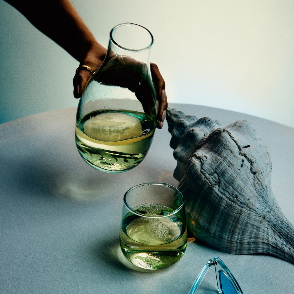 Medly Wine Carafe with white wine pouring into a Medly trattoria glass